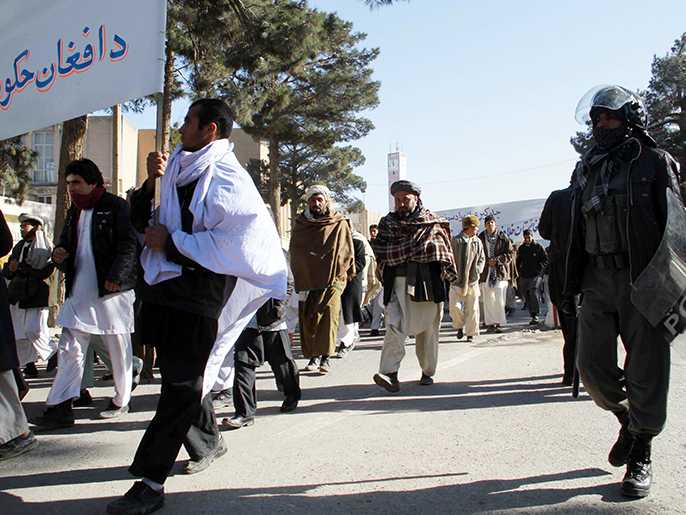 epa02530256 Afghans gather outside Iranian consulate during a protest in Herat, western Afghanistan on 15 January 2011. Dozens of Afghans on 15 January demonstrated outside the Iranian consulate in Herat, to protest Iran's blocking of large numbers of fuel trucks at the Afghan border, a move that has sent domestic fuel prices soaring as winter sets in. EPA/JALIL REZAYEE