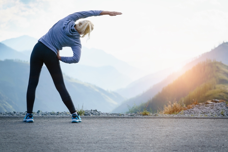 Athlete at the top of the mountain doing workout; Shutterstock ID 669229195; purchase_order: aljazeera ; job: ; client: ; other: