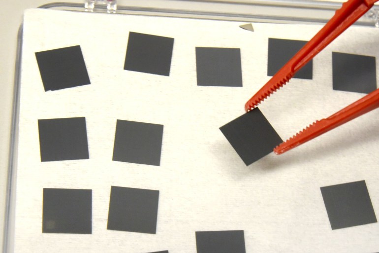 03 May 2022, Saxony-Anhalt, Halle (Saale): In the photovoltaics group of the Institute of Physics at Martin Luher University Halle-Wittenberg, physics lab technician Thomas Richter checks small silicon sheets measuring one centimeter by one centimeter before processing them. At the institute, new thin-film materials for new types of solar cells are currently being researched as part of a European research project under the direction of photovoltaics chairholderRoland Scheer. In a tandem design, they are to achieve higher efficiencies together with conventional silicon technology. The photovoltaics group is collaborating with universities and institutes in Sweden, Switzerland, Luxembourg and Magdeburg, among others, as well as module manufacturers and the Helmholtz Center. Photo: Waltraud Grubitzsch/dpa-Zentralbild/ZB (Photo by Waltraud Grubitzsch/picture alliance via Getty Images)