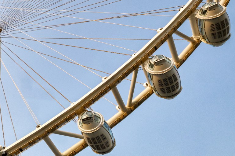 This picture taken on July 27, 2023 shows a close-up view of pods of the Ain Dubai (Dubai Eye) observation wheel in Dubai. - Two years ago, Dubai's skyscraper-studded skyline welcomed a fresh addition: a massive ferris wheel, touted as the world's largest, but which mysteriously stopped turning only months after it was inaugurated. The so-called Ain Dubai (Dubai Eye) was intended as a tourist-luring landmark in the United Arab Emirates' glam-hub, which is also home to the world's tallest building. But now, it stands idle, its extravagant light fixtures the only parts seemingly still working. (Photo by GIUSEPPE CACACE / AFP)