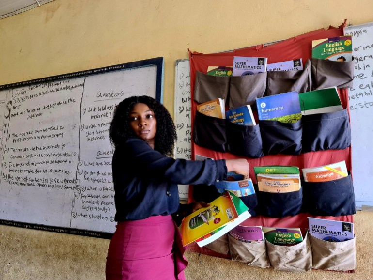 One of the coordinators of The Hanging Library initiative visits a school in Lagos after the installation of a library [Muhammed Bello/Al Jazeera]