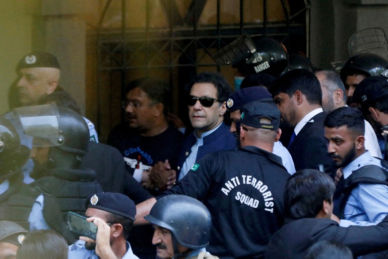 FILE PHOTO: Security officers escort Pakistan's former Prime Minister Imran Khan as he appeared in Islamabad High Court, Islamabad, Pakistan, May 12, 2023. REUTERS/Akhtar Soomro/File Photo