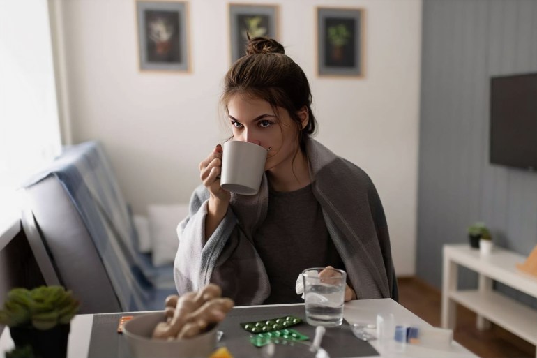 Sick lady drinking ginger tea