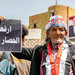 متظاهر يحمل لافتة ضمن حشود خرجت تنادي برفع حصار تعز أمس (أ.ف.ب)