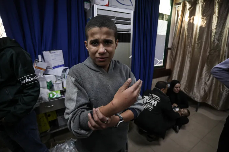 Mohammed Odeh, 14, was separated from his family and taken with at least 150 other men and teenage boys to a rice warehouse by Israeli forces where he faced torture for several days [Abdelhakim Abu Riash/Al Jazeera]