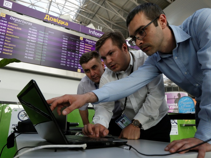 Technicians work on a flight timetable for the airport's site at the capital's main airport, Boryspil, outside Kiev, Ukraine, June 27, 2017. REUTERS/Valentyn Ogirenko TPX IMAGES OF THE DAY