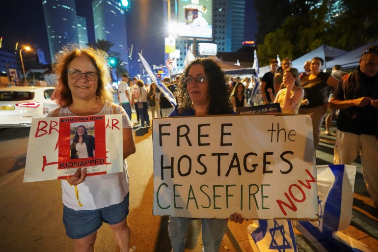 People hold placards during a demonstration to show support and solidarity with the families of hostages who are being held in Gaza, amid the ongoing conflict between Israel and Hamas, in Tel Aviv, Israel, October 21, 2023. REUTERS/Janis Laizans