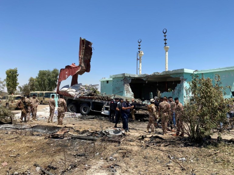 Iraq's Joint Operations Command soldiers inspect the truck and the site from where rockets were launched towards Ain Al-Asad Military Base, at Anbar province, in al-Baghdadi, Iraq, July 8, 2021. Joint Operations Command Media Office/Handout via REUTERS ATTENTION EDITORS - THIS IMAGE WAS PROVIDED BY A THIRD PARTY.