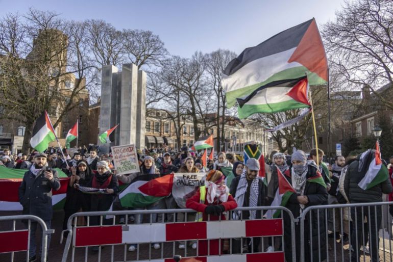 HAGUE, NETHERLANDS - JANAURY 26: People gather outside the International Court of Justice during the session on the day the International Court of Justice (ICJ) rule on Gaza genocide case against Israel made by South Africa in the Hague, the Netherlands on January 26, 2024. The Peace Palace of the International Court of Justice was surrounded by journalists and protesters awaiting the court's interim ruling. The International Court of Justice (ICJ) announced its decision regarding the request for interim measures in the case. (Photo by Nikos Oikonomou/Anadolu via Getty Images)