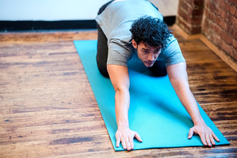 Man preparing for Extended Puppy pose