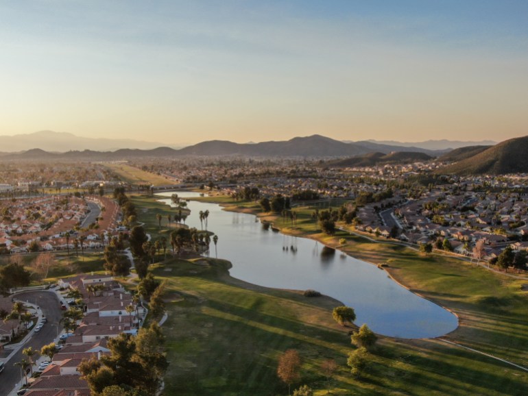 Aerial view of golf course surrounded by town houses and luxury villas during sunset time. Temecula, California, USA