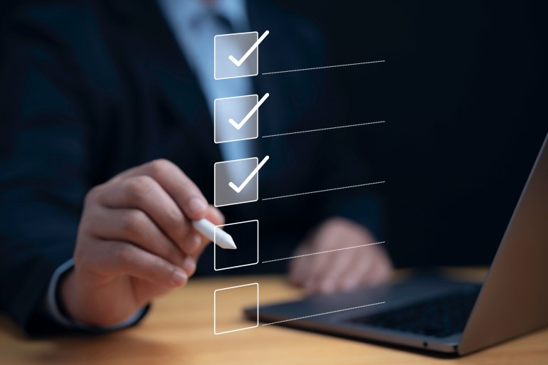 Check list concept.Businessman using laptop with online checklist survey, filling out digital form checklist, take an assessment, questionnaire, evaluation, online survey, online exam; Shutterstock ID 2400635831; purchase_order: aljazeera ; job: ; client: ; other: