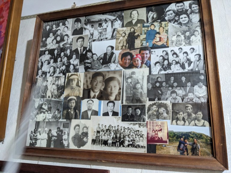 A photo collage hanging on the wall of Viktor An’s Tashkent apartment, with his parents in the centre [Ruairi Casey/Al Jazeera]