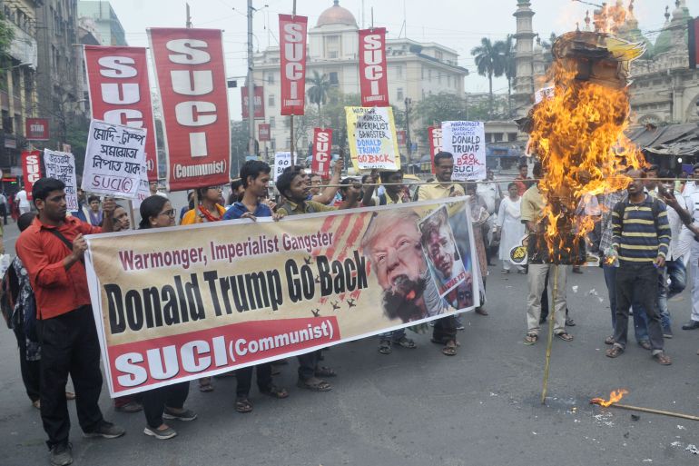 Socialist Unity Centre of India (Communist) or SUCI(C ) activists burning effigy of US President Donald Trump during a rally to protest against US India visit