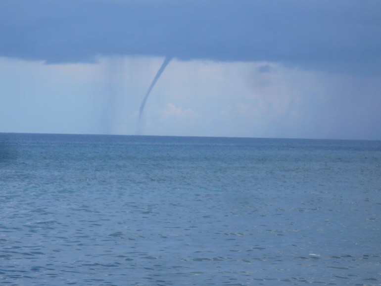 A waterspout from a storm over the sea southeast of Dumaguete City, Negros Oriental, Philippines