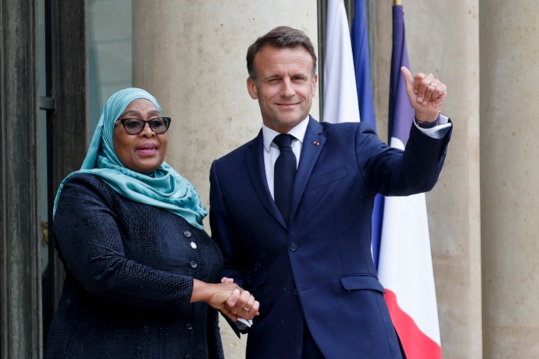 France's President Emmanuel Macron (R) shakes hands with Tanzania's President Samia Suluhu Hassan ahead of a meeting as part of the "Summit on Clean Cooking in Africa" at the Elysee Presidential Palace in Paris on May 14, 2024. (Photo by Ludovic MARIN / AFP)