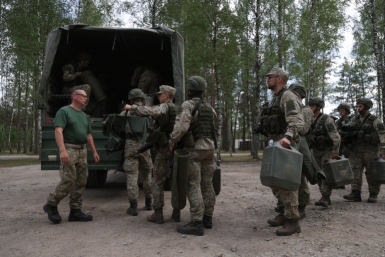 RUDNINKAI, LITHUANIA - MAY 28: Reservists in an infantry unit of the Lithuanian Army prepare to deploy during training at a military site that is to become home for 5,000 German troops on May 28, 2024 near Rudninkai, Lithuania. The site, located approximately 12km from the border to Belarus, is a former Soviet military training ground. Germany, which already has a strong military presence in Lithuania as part of an international NATO force, will deploy 5,000 troops with heavy equipment in its "Lithuania Brigade" on a long-term commitment to help deter aggression from Russia. The brigade is scheduled to be fully operational by 2027. (Photo by Sean Gallup/Getty Images)