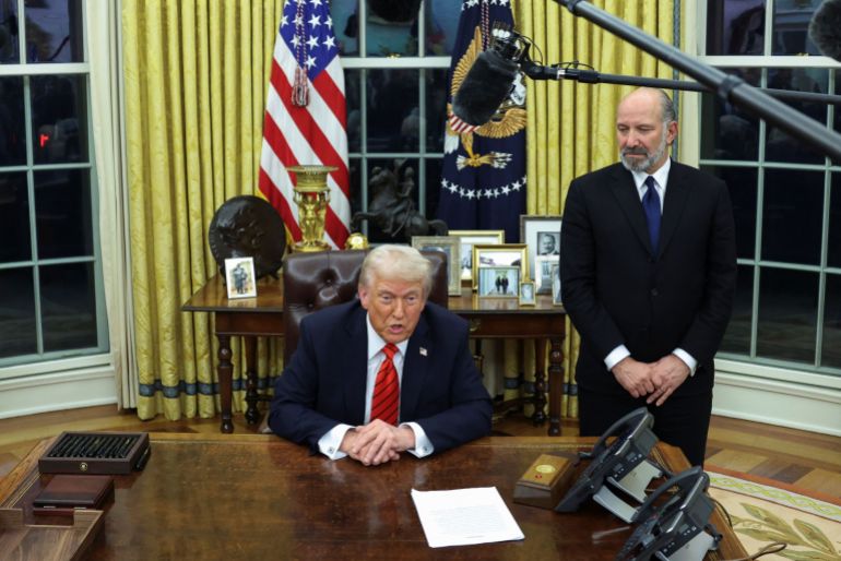 U.S. President Donald Trump signs an executive order in the Oval Office of the White House in Washington