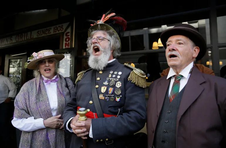 Joseph Amster, centre, dressed as Emperor Norton, sings ‘I Left My Heart in San Francisco’ at the end of a parade to remember the great San Francisco 1906 earthquake and fire’s 110th anniversary on Friday, April 15, 2016, in San Francisco [Eric Risberg/AP]