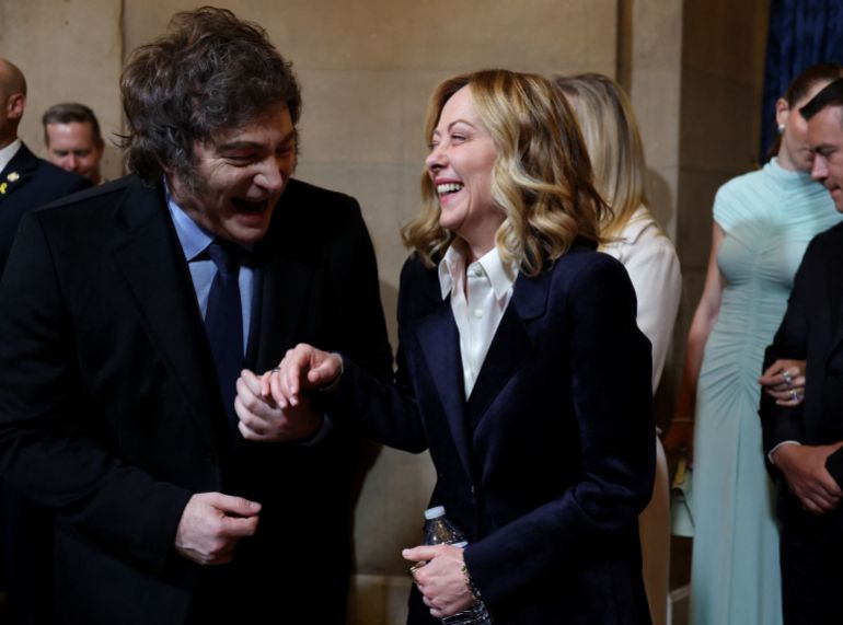 Italian Prime Minister Giorgia Meloni and Argentina's President Javier Milei laugh as they arrive for the Presidential Inauguration of Donald Trump at the Rotunda of the U.S. Capitol in Washington, U.S. January 20, 2025. REUTERS/Evelyn Hockstein