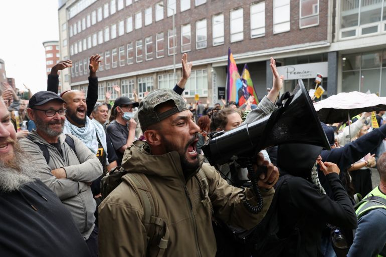People gather for a "Defend Refugees: Stop the Far Right" rally organised by campaign group Stand Up To Racism in support of immigrants, outside the Richmond hotel in Liverpool, Britain, August 9, 2025. REUTERS/Temilade Adelaja